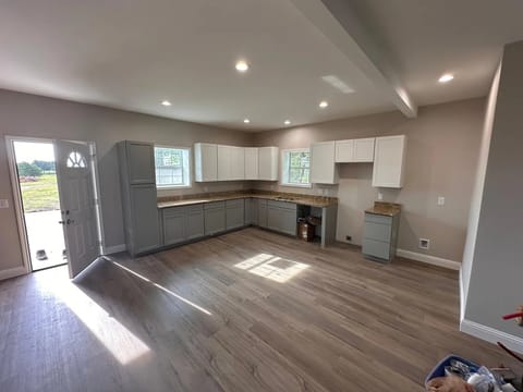 Finished kitchen with gray shaker cabinets and butcher block