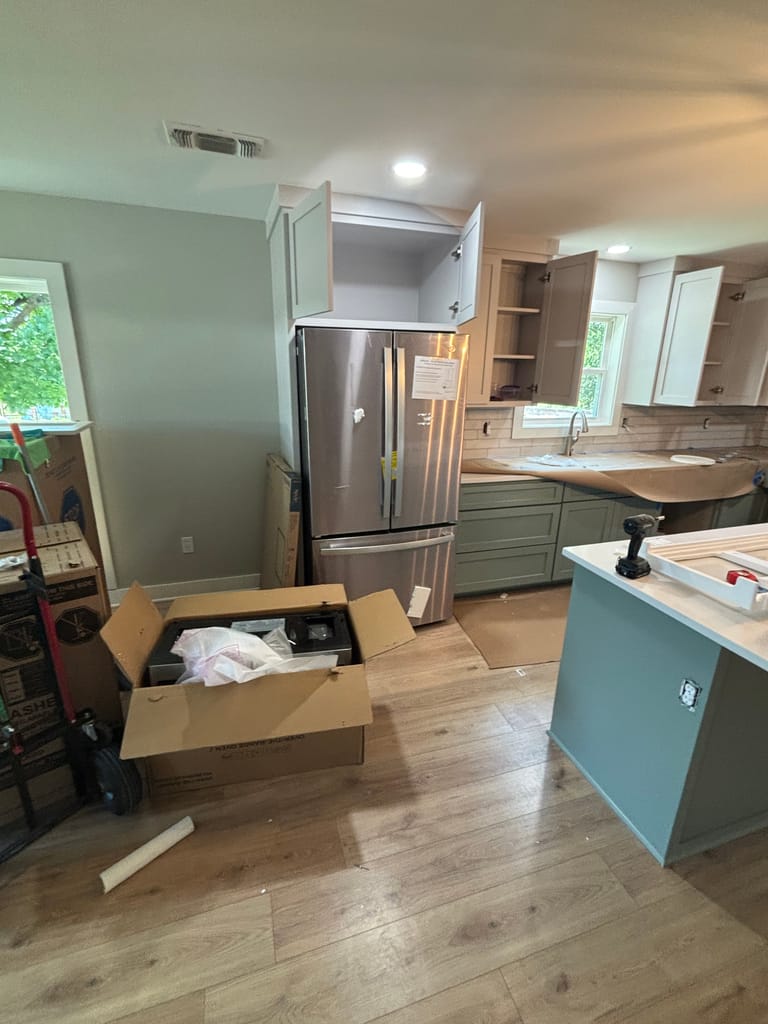 Full kitchen view with sage green island