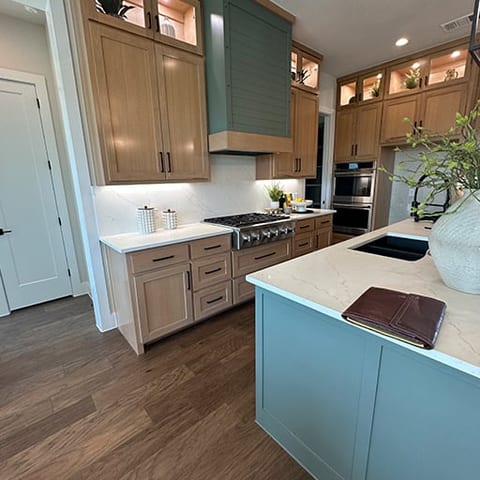 Custom kitchen with two-tone teal and white oak cabinetry