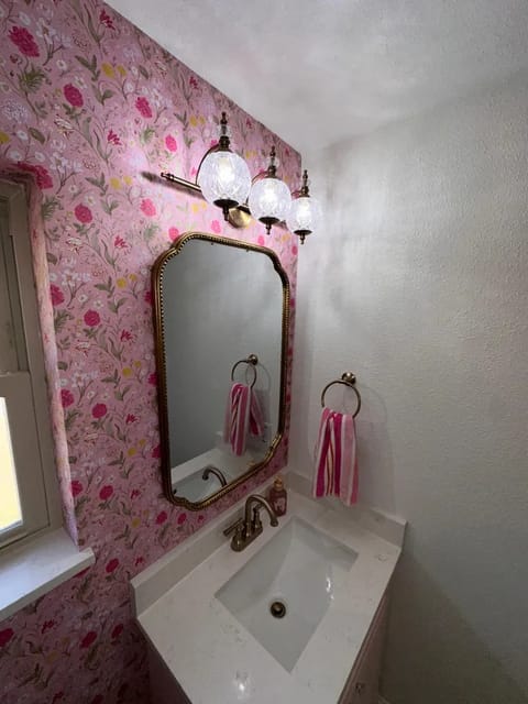 Powder bath vanity with brass mirror