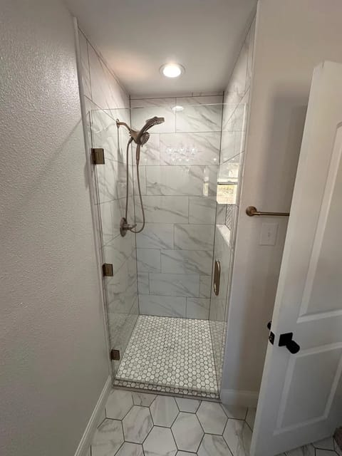 Marble shower with brass fixtures