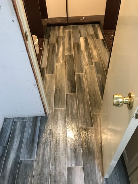 Wood look tile with brass fixture